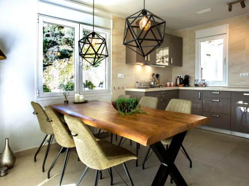 a kitchen with a wooden table and chairs at Villa Villa Cara Mull Alcalalí by Interhome in Alcalalí