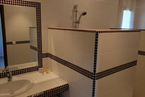 a bathroom with a sink and a mirror at Villa avec piscine près de l'océan. in Cap Skirring