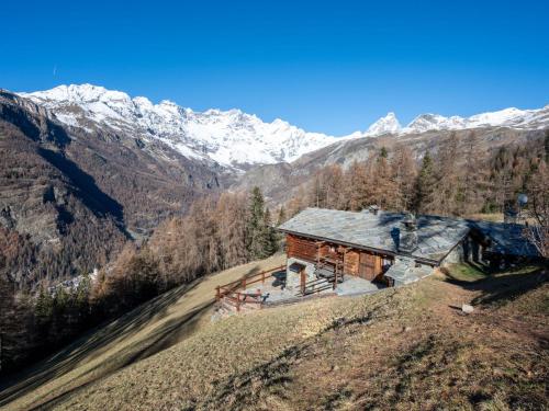 a cabin on a hill with mountains in the background at Studio Ancienne Bergerie Studio 3 by Interhome in Valtournenche