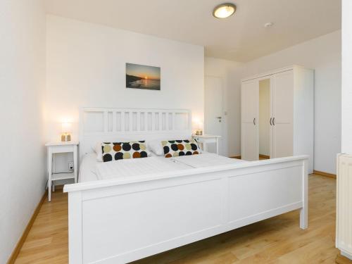 1 dormitorio blanco con 1 cama blanca grande con almohadas en Apartment Niewald by Interhome, en Ostseebad Koserow
