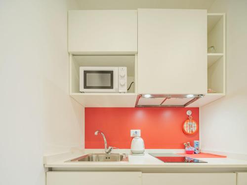 a kitchen with a sink and a microwave at Studio Rosso by Interhome in Rapallo