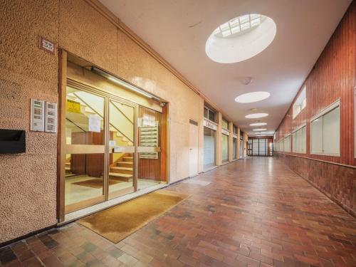 an empty hallway of an office building with a large window at Studio Rosso by Interhome in Rapallo