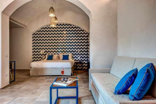 a living room with a couch and a bed at GOCCE VILLAS - Villa Degli Dei Maestrale in Vico Equense