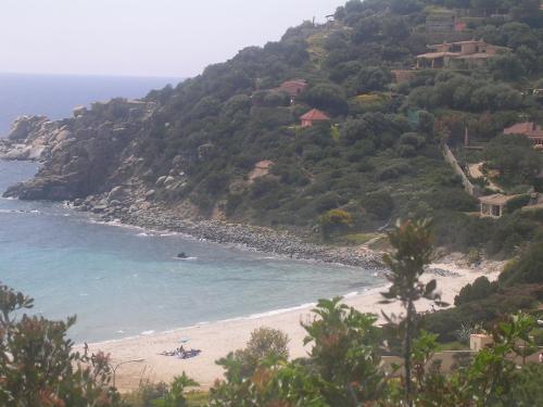 a view of a beach with people in the water at La Lantana Nuova in Flumini di Quartu