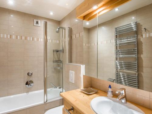 a bathroom with a sink and a shower and a tub at Appartement Méribel, 4 pièces, 6 personnes - FR-1-565-47 in Les Allues