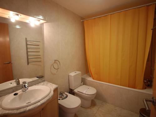 a bathroom with a sink and a toilet and a shower at Apartamento Llançà, 2 dormitorios, 5 personas - ES-228-74 in Llança