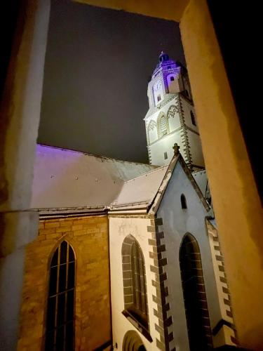a church with a clock tower on top of it at Pension am Markt Meißen in Meißen