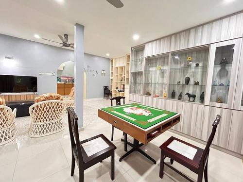 a living room with a table and chairs in it at Blossom seremban spacious comfy in Seremban