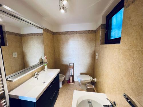 a bathroom with a sink and a toilet at Casa Luca 1C in Sasso