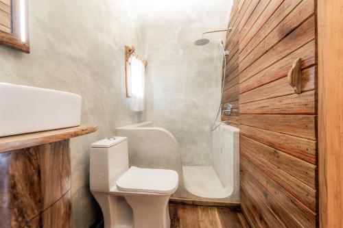 a small bathroom with a toilet and a sink at Makofi Guest House in Nungwi