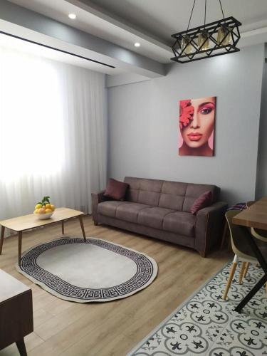 a living room with a couch and a table at Flat near the sea in Erdemli