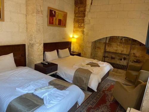 Una cama o camas en una habitación de Muzepotamia Butik Otel