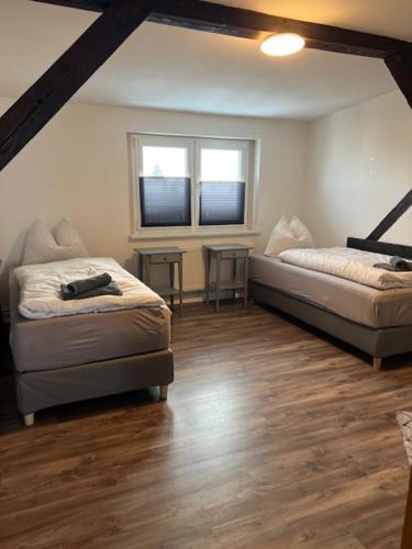 a living room with two beds and a window at Gästewohnung Eberswalde in Eberswalde