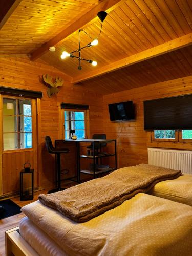 a bedroom with a bed in a room with a bar at Glamping Hütte Hygge in Winterberg