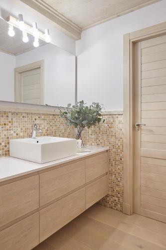 a bathroom with a white sink and a mirror at Casa Val de Ruda Luxe 71 by FeelFree Rentals in Naut Aran