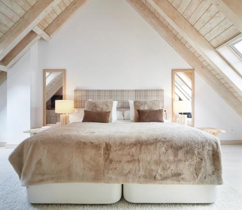 a bedroom with a large bed and two mirrors at Casa Val de Ruda Luxe 71 by FeelFree Rentals in Naut Aran