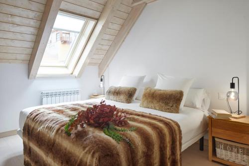 a bedroom with a large white bed with a window at Casa Val de Ruda Luxe 71 by FeelFree Rentals in Naut Aran