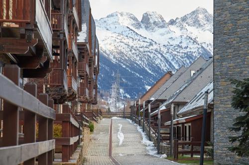 a street in a town with mountains in the background at Casa Val de Ruda Luxe 71 by FeelFree Rentals in Naut Aran
