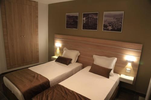 2 camas en una habitación de hotel con luces en MONDIAL HOTEL en Túnez