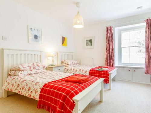 a bedroom with two beds and a window at 3 Bed in Llangorse BN331 in Cathedine