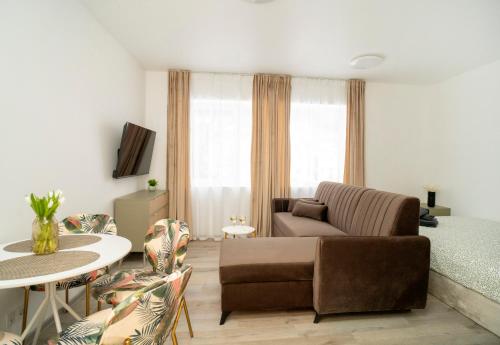 a living room with a couch and a bed and a table at Central Station Apartment No8 in Kaunas