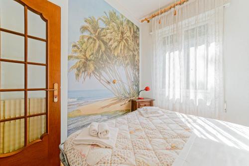 a bedroom with a bed with a mural of a beach at Apartment Vespucci by PortofinoVacanze in Rapallo