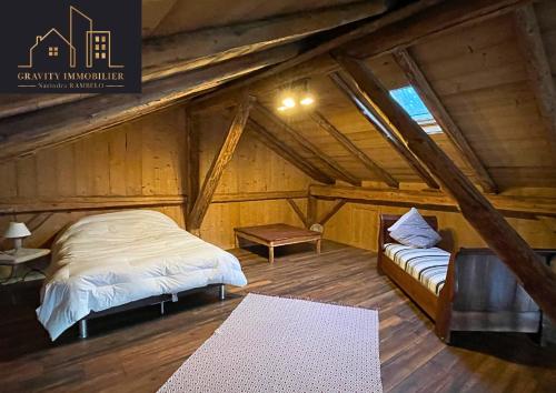 a bedroom with two beds in a attic at Luxueux chalet 5 chambres in Brizon