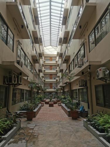an empty hallway with potted plants in a building at Unit 402, Cedar Peak in Baguio