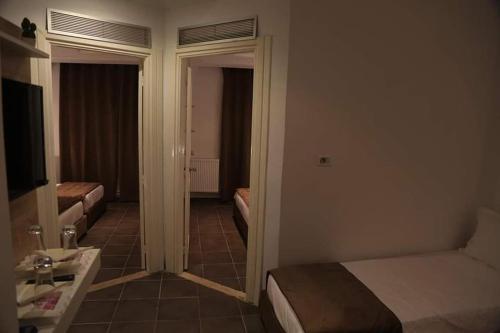a hotel room with a bedroom with a bed and a bathroom at MONDIAL HOTEL in Tunis