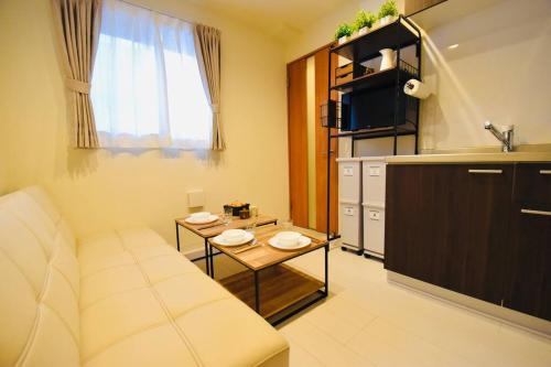 a living room with a couch and a table at Craft302 浅草 スカイツリー近く 貸切最大5人 東京観光に最適 無料WiFi in Tokyo