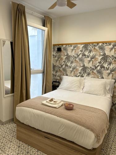 a bedroom with a large bed with a bowl on it at EME SEVILLA TURISTICA in Seville