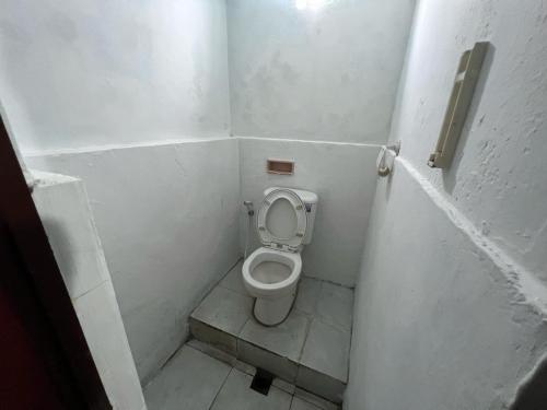 a small bathroom with a toilet in a stall at Faire BNB Homestay in Timuran