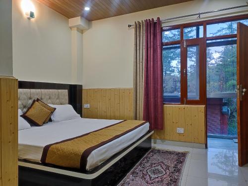 a bedroom with a bed and a large window at Vintage Woods Inn in Shimla