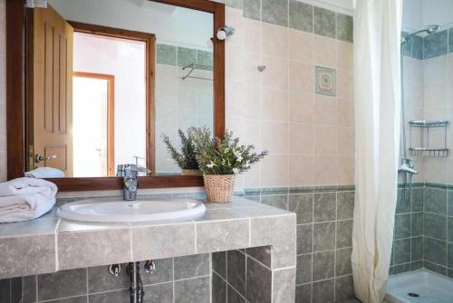 a bathroom with a sink and a mirror at Villa Olga in Katelios
