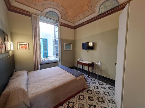 Postel nebo postele na pokoji v ubytování B&B Residenza d'epoca "La nostra casa tra le torri"
