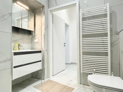a bathroom with a toilet and a glass shower at Premium Residence at famous Vienna Kutschkermarkt in Vienna
