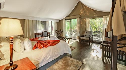 a bedroom with a bed in a tent at Phelwana Game Lodge in Hoedspruit