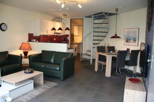 a living room with a couch and a table at Heggerank 32 in Nieuwvliet