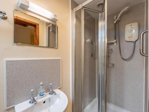 a bathroom with a sink and a shower at 4 Bed in Longtown 86497 in Llanveynoe
