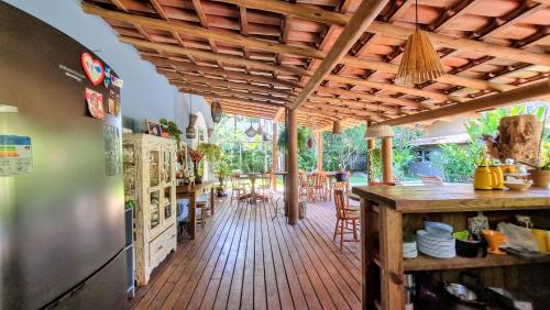 a kitchen with a wooden deck with a table and chairs at Vila Pitanga Trancoso in Trancoso