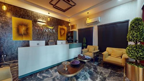 a lobby with a reception desk and chairs and a table at YANNA APARTMENT BY KHALIQUES in Abuja