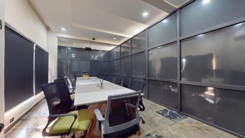 a conference room with a white table and chairs at YANNA APARTMENT BY KHALIQUES in Abuja