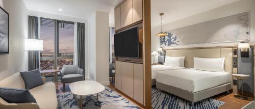 a hotel room with a bed and a tv at Hilton Mall Of Istanbul in Istanbul