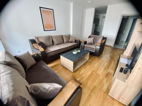 a living room with couches and a coffee table at BK2 APARTMAN in Kragujevac