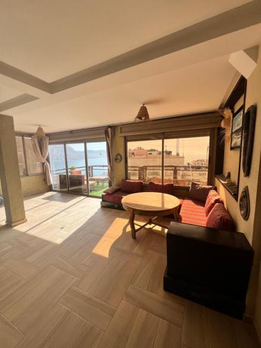 a living room with a couch and a table at Auberge guest house imsouane n°5 in Imsouane