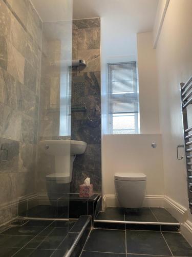 a bathroom with a toilet and a sink at Central London Double Bedroom by Station in London