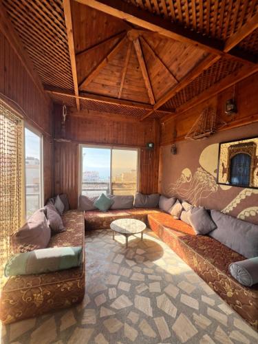 a living room with couches and a table at Auberge guest house imsouane n°5 in Imsouane