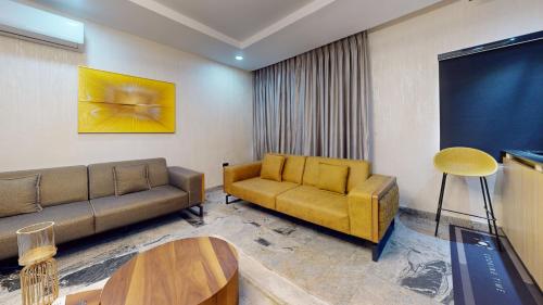 a living room with a couch and a table at YANNA APARTMENT BY KHALIQUES in Abuja