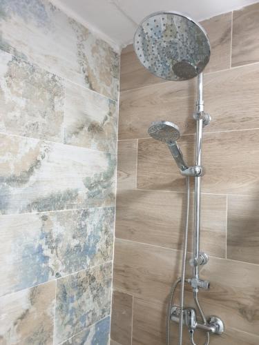 a shower head in a bathroom next to a wall at CALTERR - Loft con Terraza privada, Wifi, Recién reformado in Torremolinos