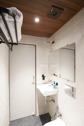a bathroom with a sink and a mirror at Palm Springs Beach Resort - Gorai in Mumbai